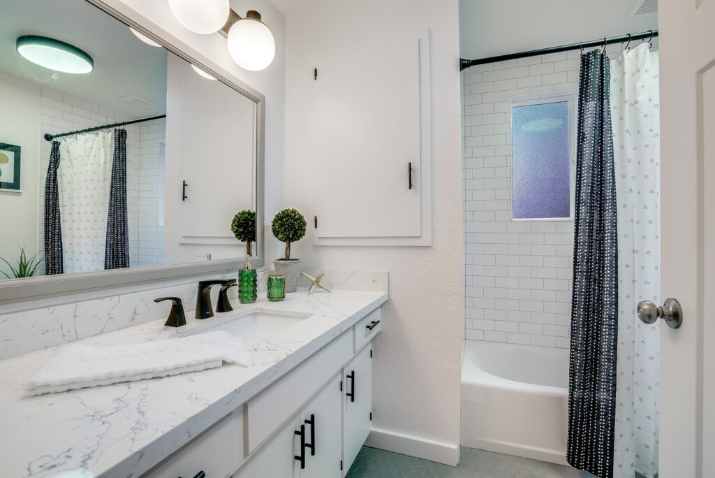 Green subway tile kitchen backsplash installed by professional tilers.
