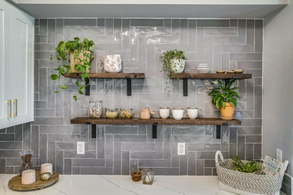 Herringbone gray kitchen backsplash installed by professional tilers.